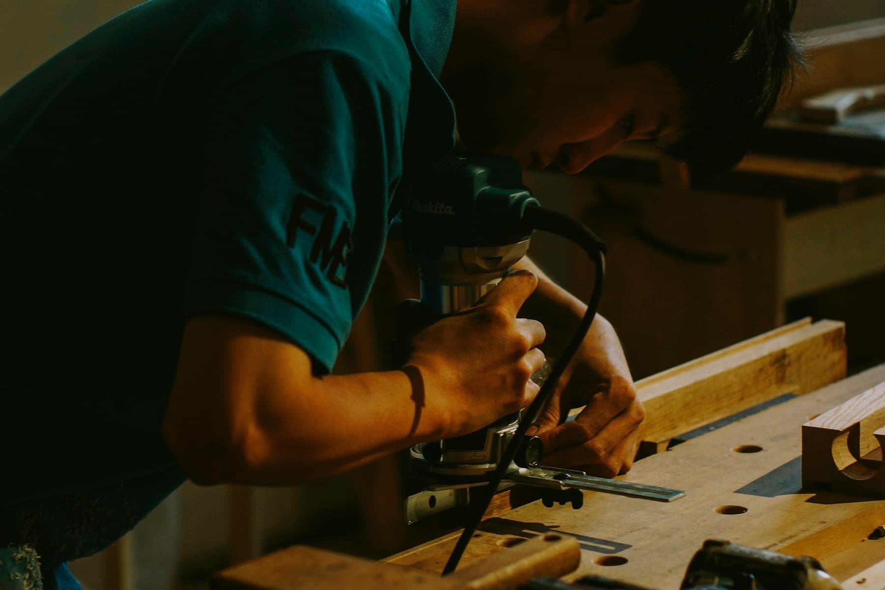 Craftsperson producing bespoke furniture with precision