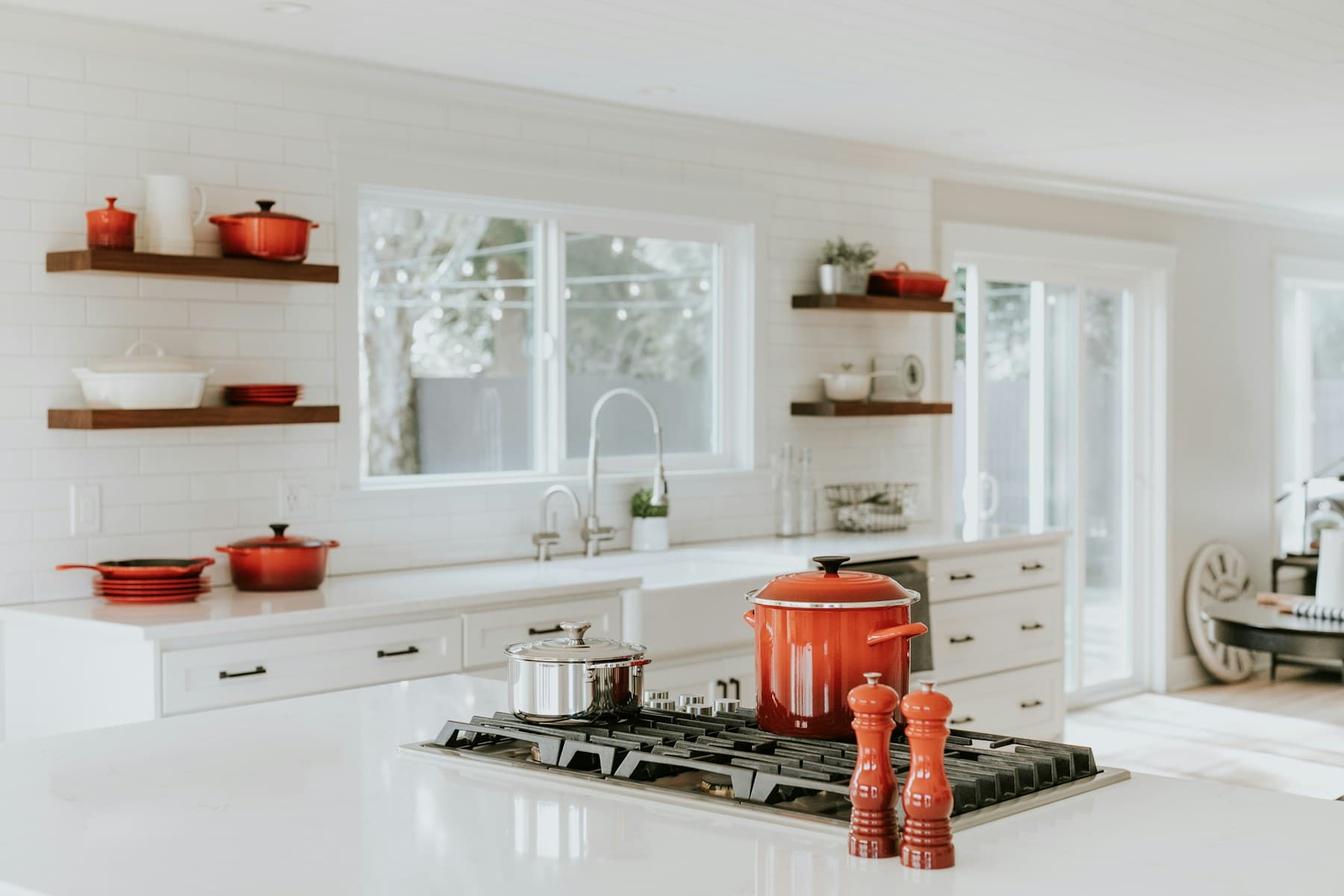 Light bespoke kitchen with an island and oak shelves