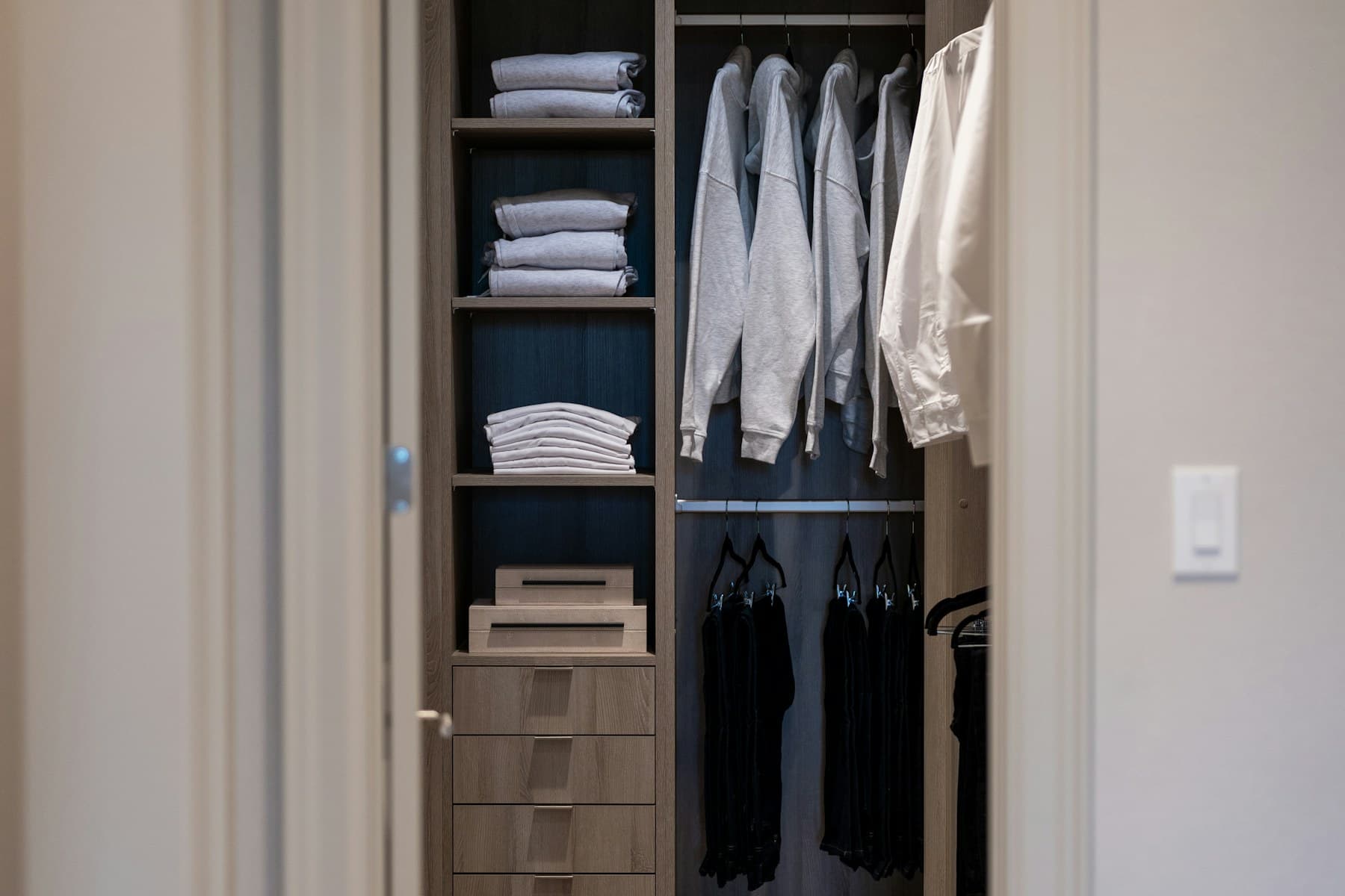 Dark bespoke wardrobe with shelves and drawers